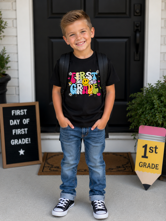 Kids Tee — "First Grade" Colorful Retro Smiley School T‑Shirt