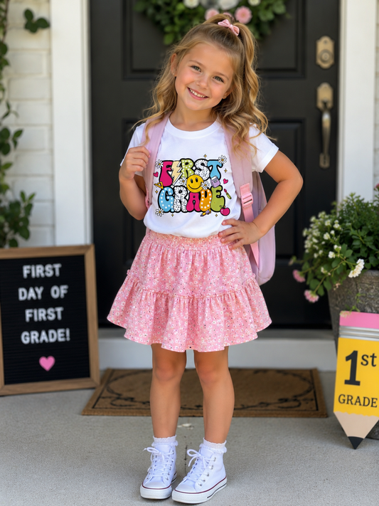 Kids Tee — "First Grade" Colorful Retro Smiley School T‑Shirt